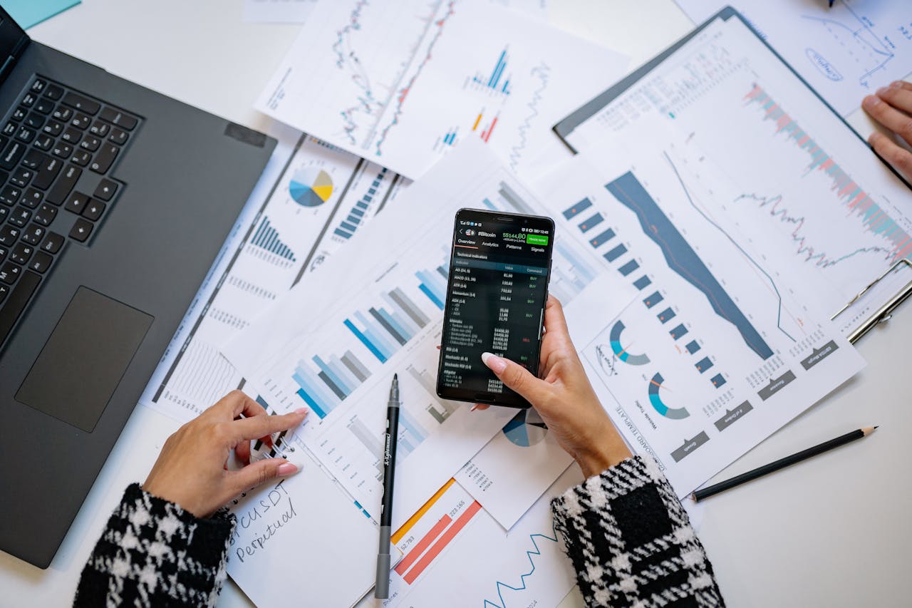 Home A top view on charts and smartphone in an office, showcasing data analytics.